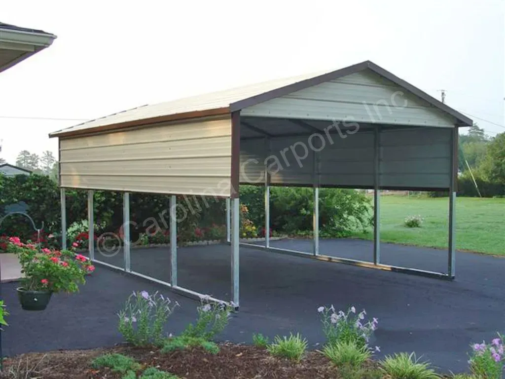 Tan and brown carport on a black driveway, metal posts.