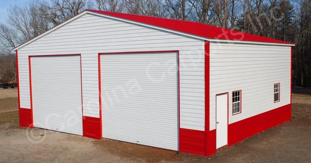 Two-bay white and red metal garage with a red roof, two garage doors, and a side door.
