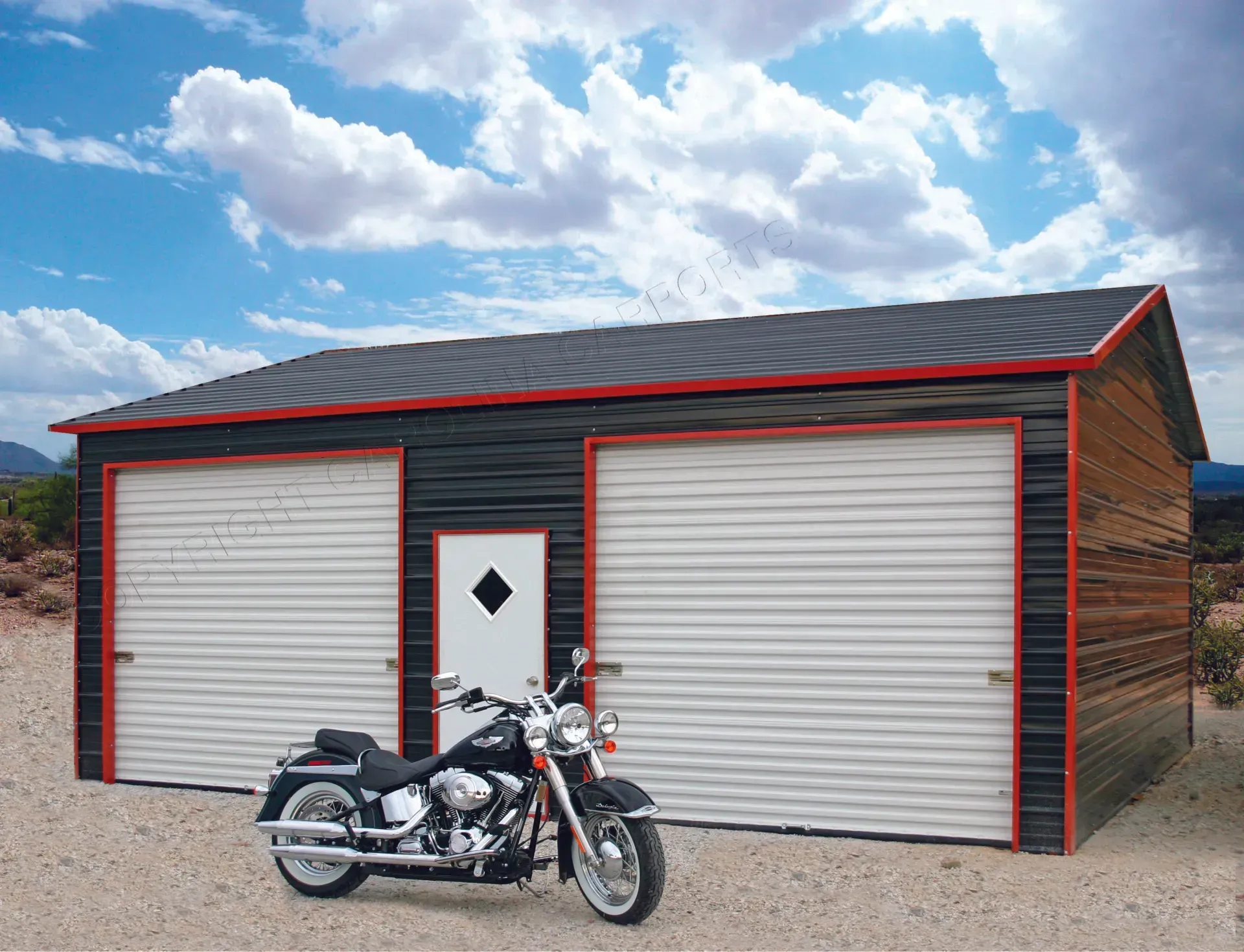 Black and red garage with two white roll-up doors, a motorcycle in front, against a desert sky.