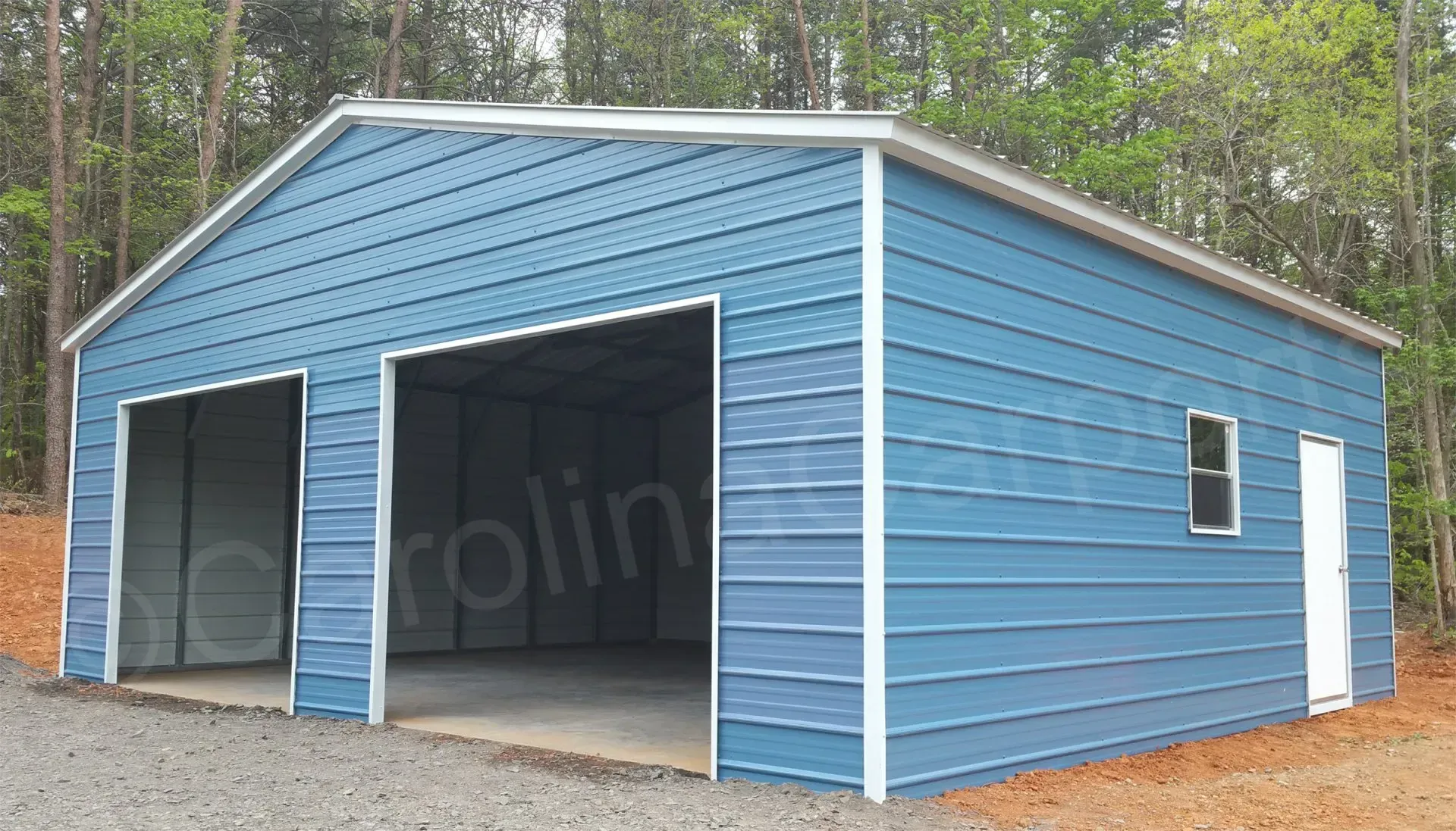 Blue metal garage with two bays, a side door, and a window.