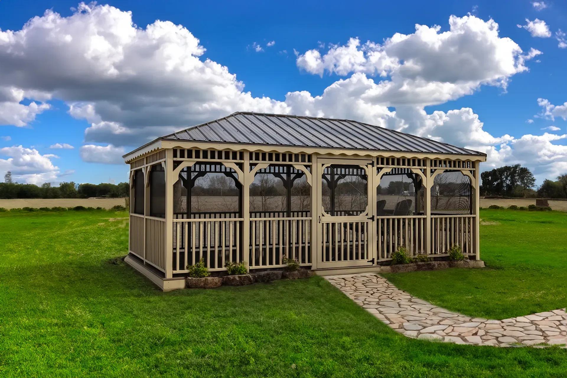 White gazebo with screened walls, stone path, on green lawn, blue sky with clouds.