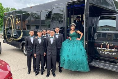 A group of people are standing in front of a limousine.