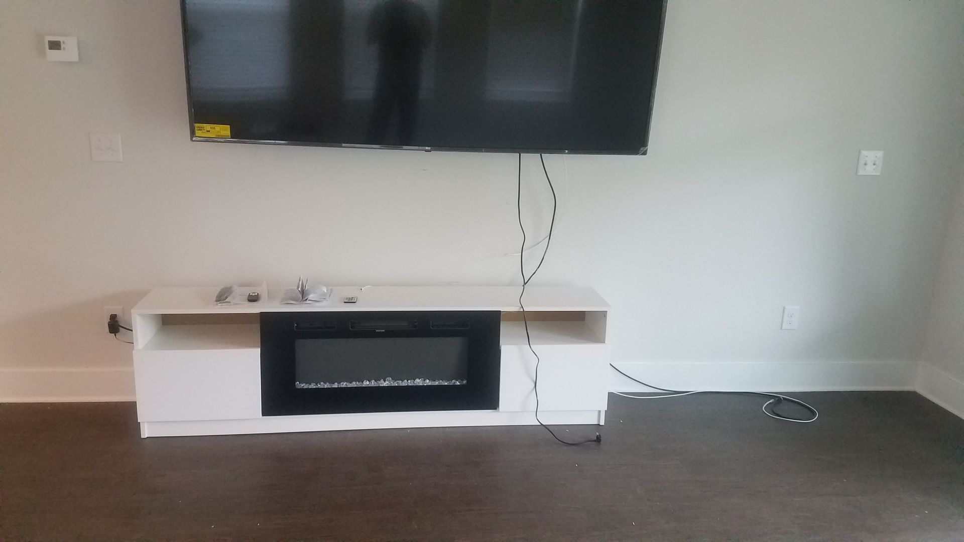 A basement filled with plastic and a brick wall.