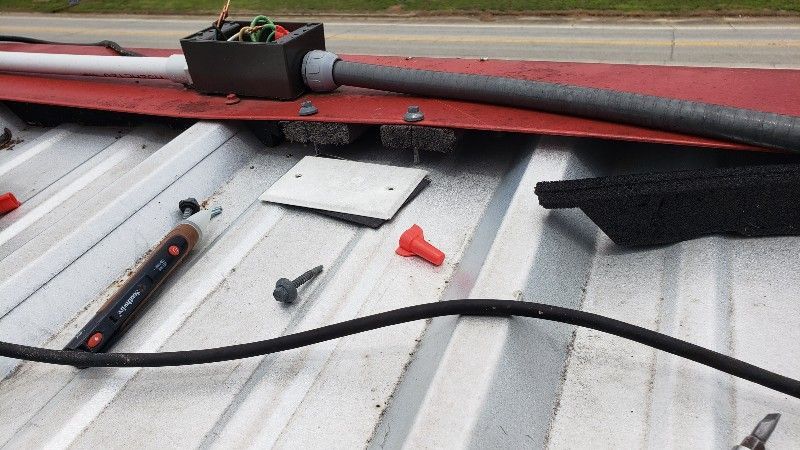 A roof with a bunch of wires laying on it