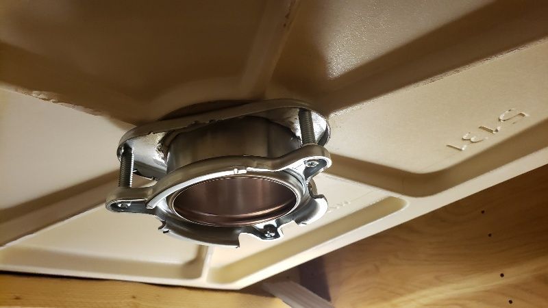 A metal object is hanging from the ceiling of a room.