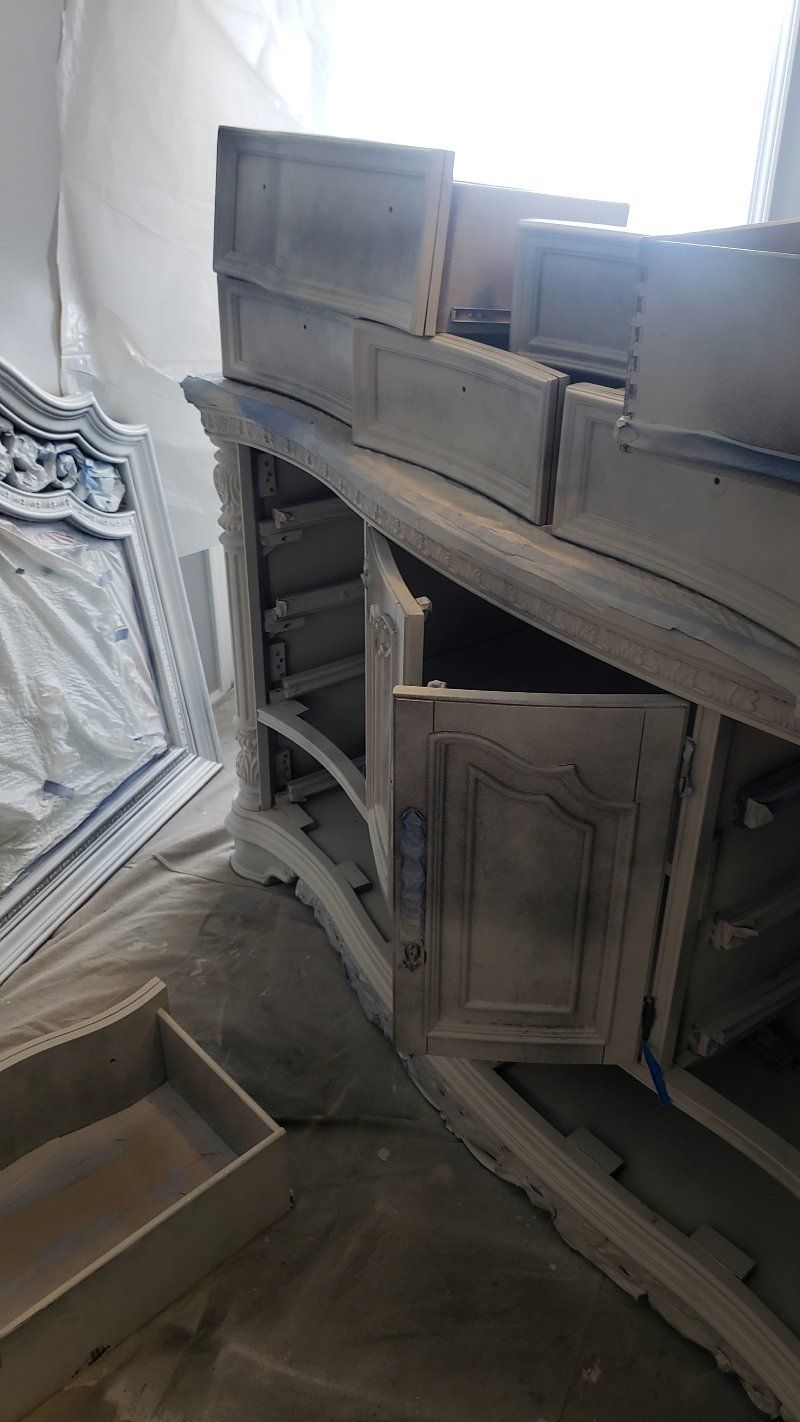 A dresser with its doors open is sitting on the floor in a room.