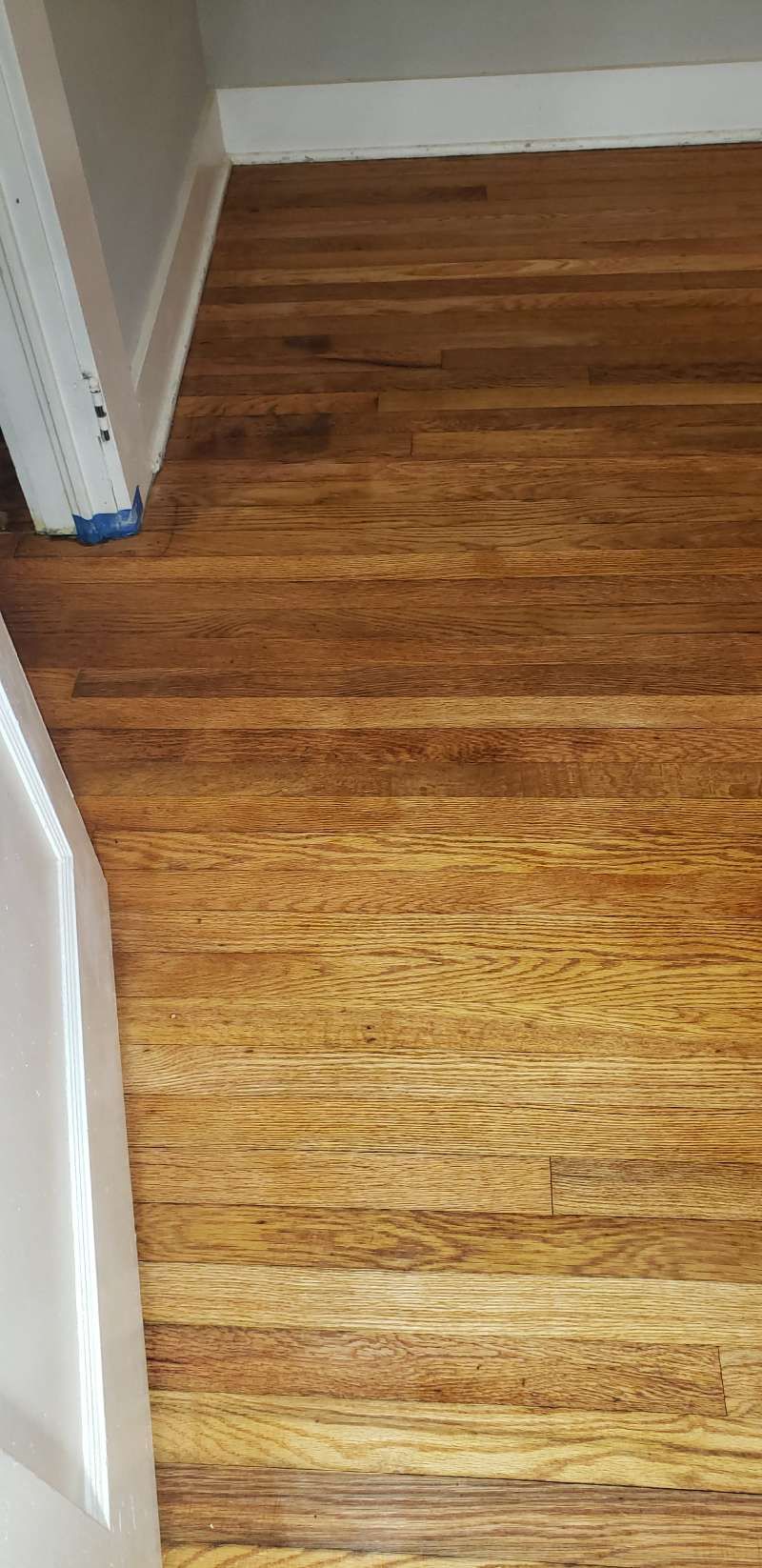 A close up of a wooden floor in a room.
