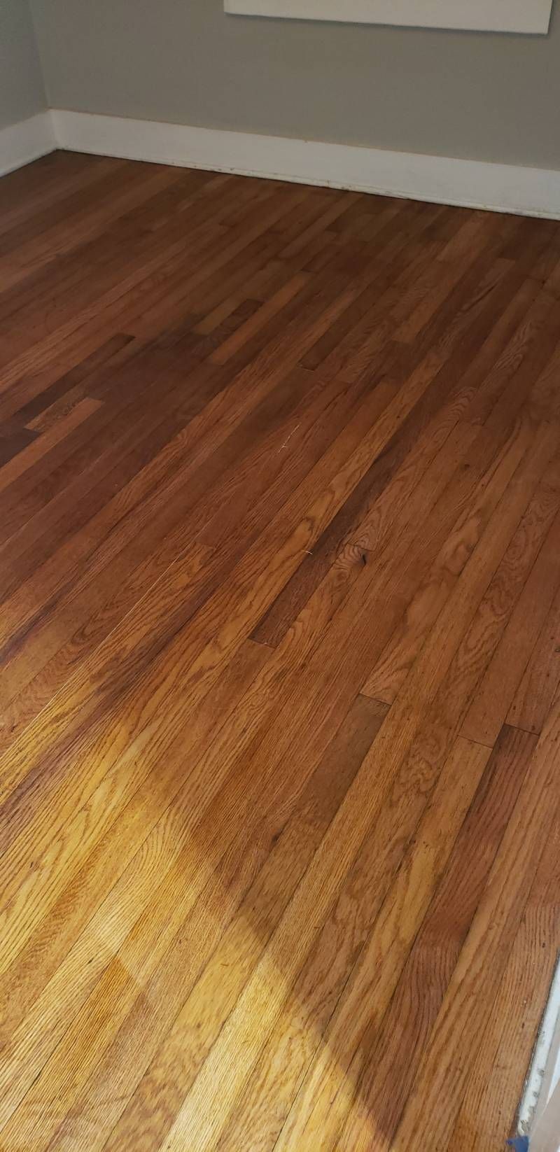 A room with a wooden floor and a window.