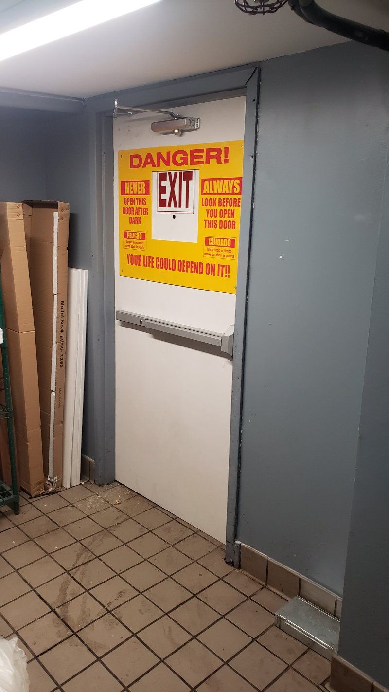 A door with a sign on it that says `` danger ! exit ''.