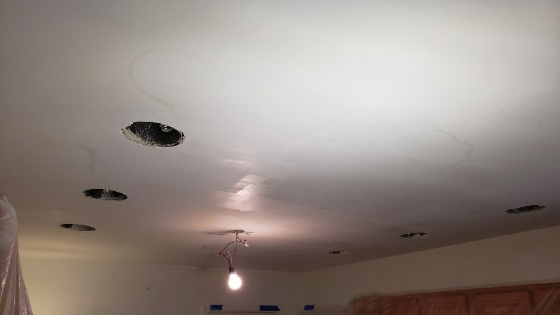 A light bulb is hanging from the ceiling of a room.