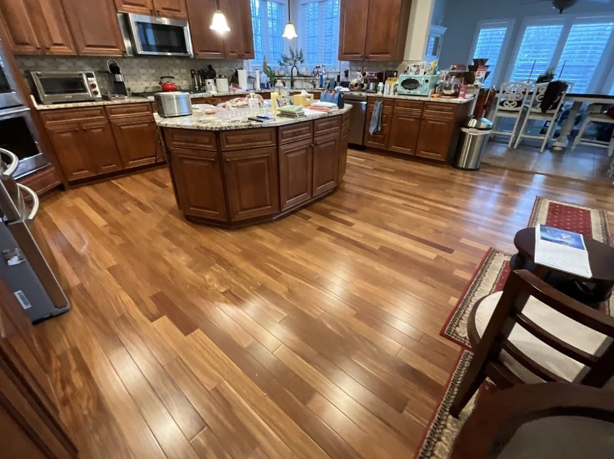 A kitchen with hardwood floors and stainless steel appliances.