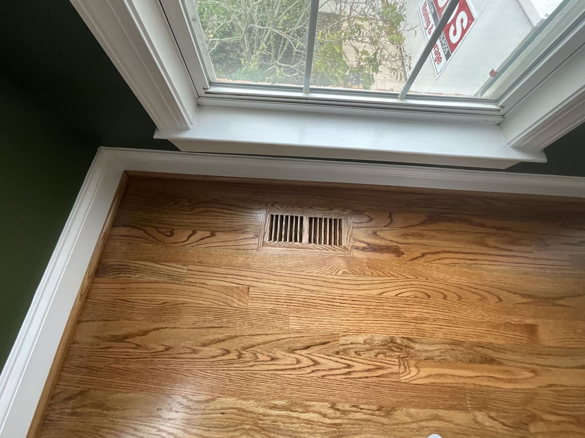 A room with hardwood floors and a window.