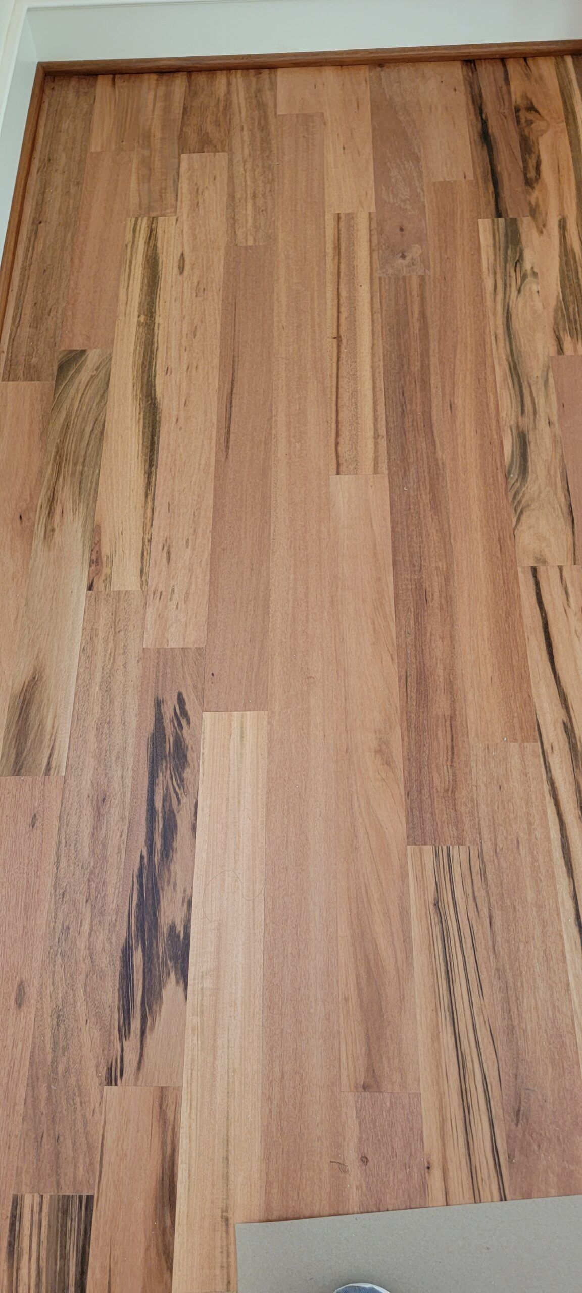 A close up of a wooden floor in a room.