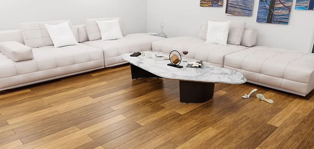 A living room with a couch and a coffee table on a wooden floor.