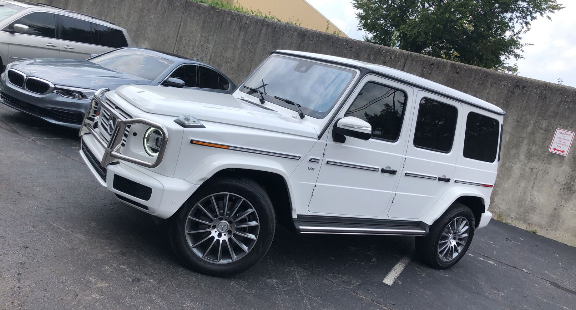 White Mercedes Benz V8 with tinted windows