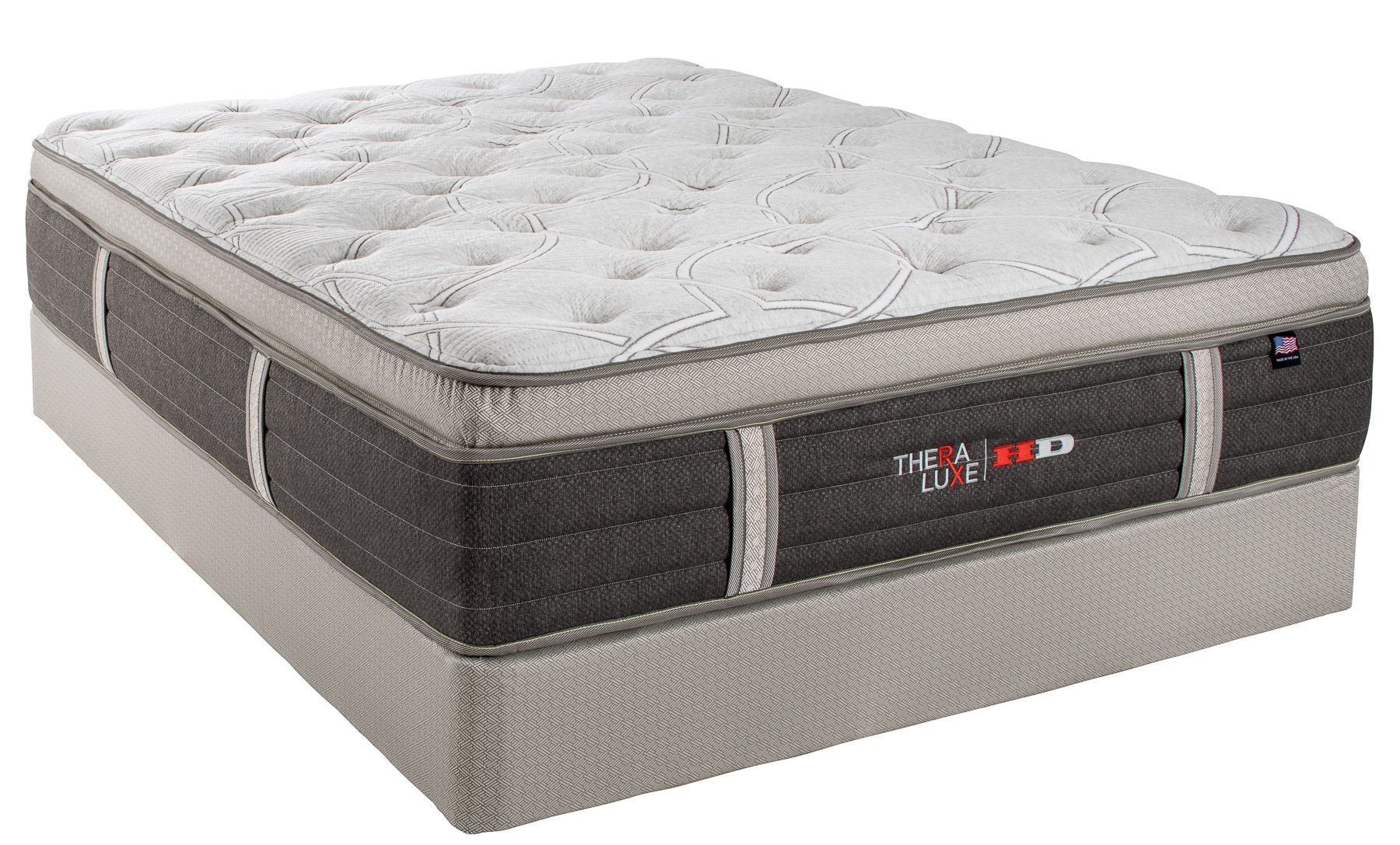 Gray and white pillow-top mattress with a dark side panel and logo, shown on a plain background