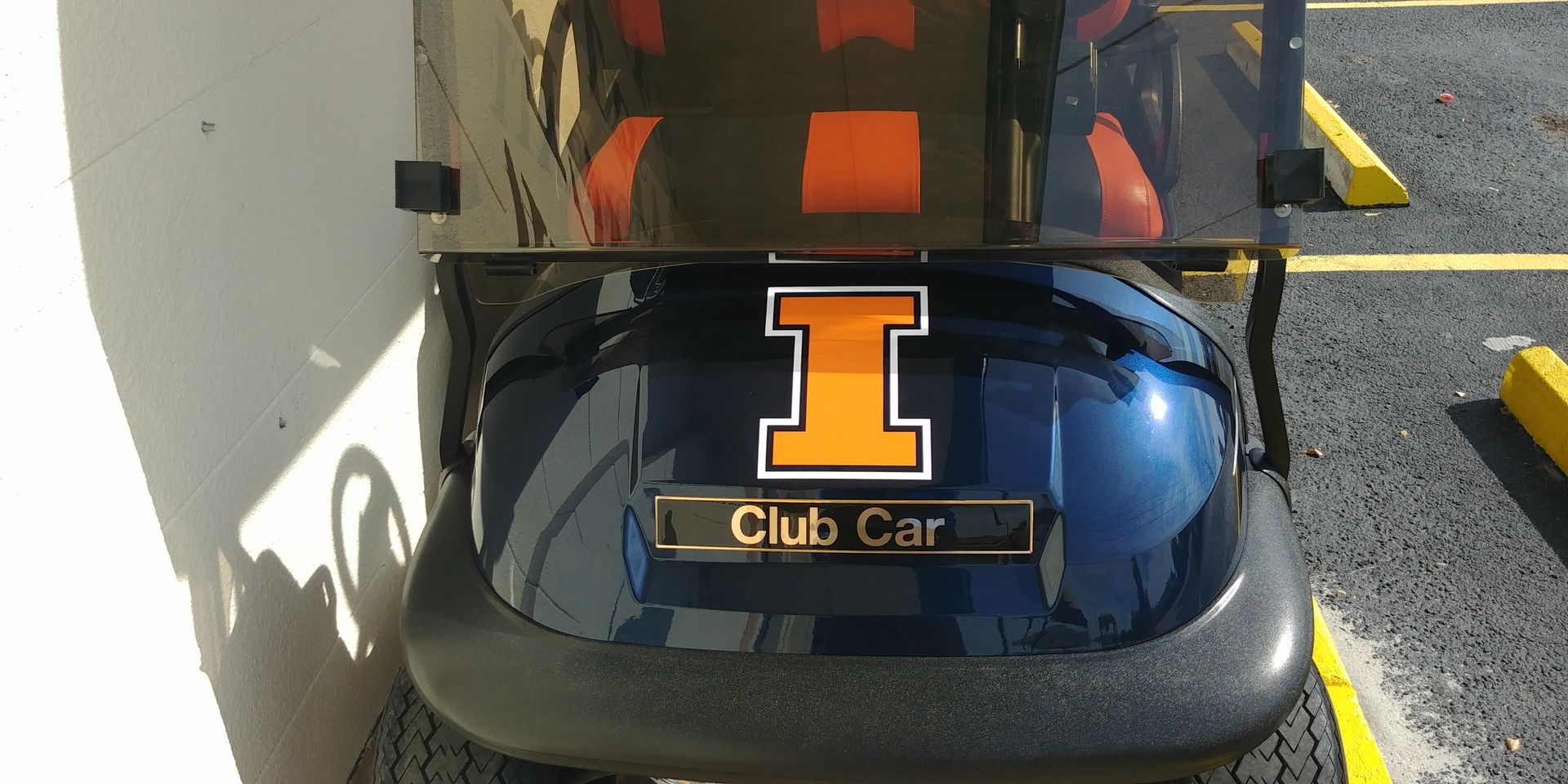 A dark blue Club Car golf cart with an orange University of Illinois 