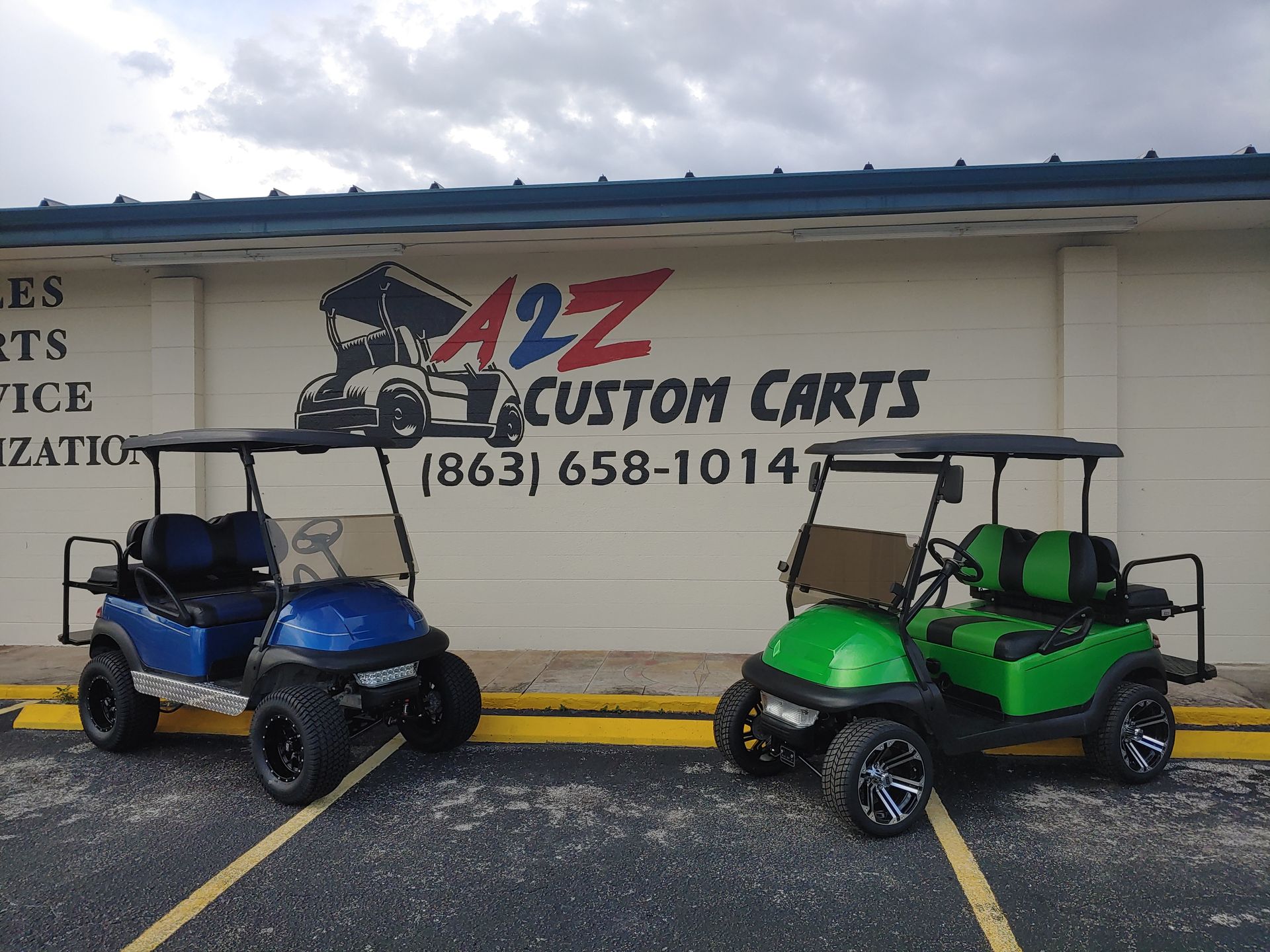 Two custom golf carts in front of a store with a logo that says 