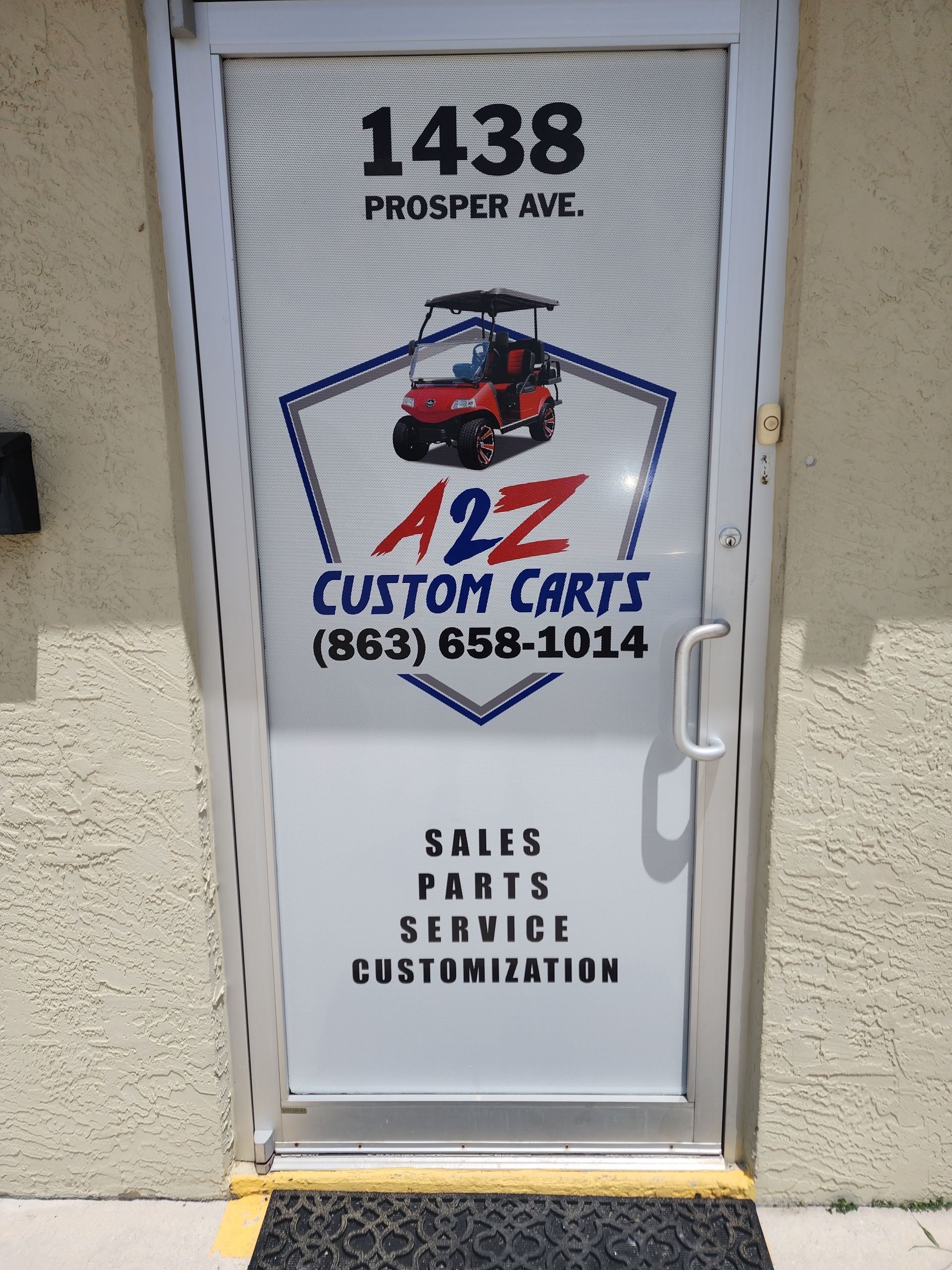 A2Z Custom Carts storefront door with logo, address 1438 Prosper Ave., and contact information.