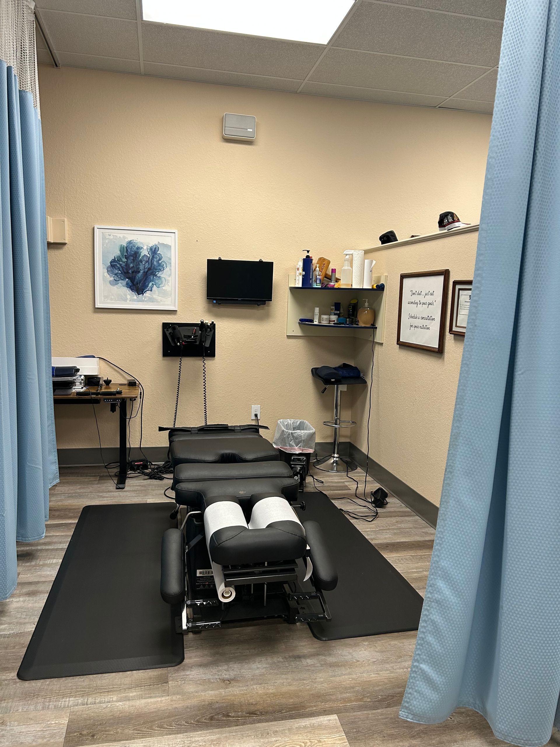 A room with a bed and a television on the wall.