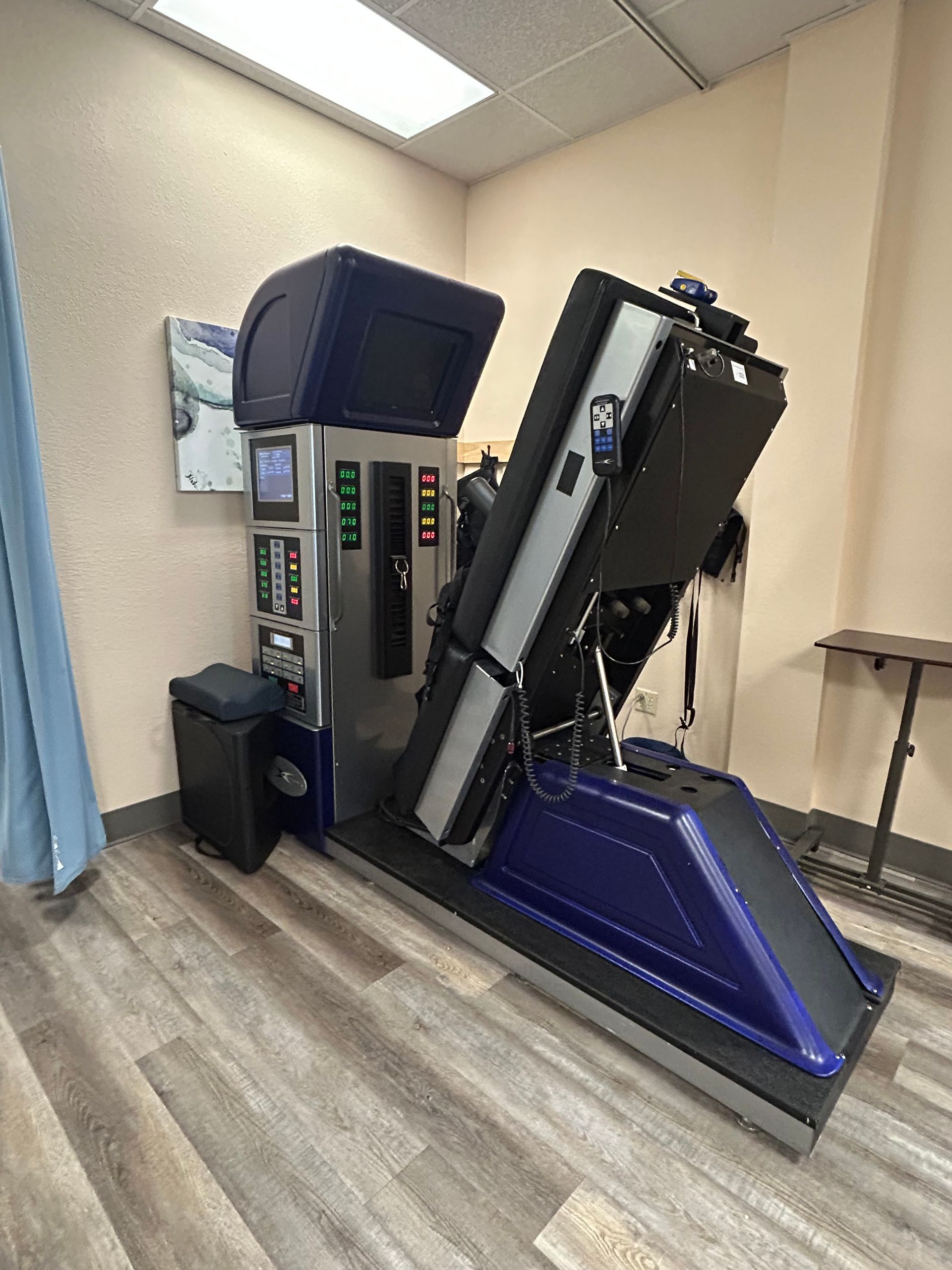 A machine is sitting on a wooden floor in a room.