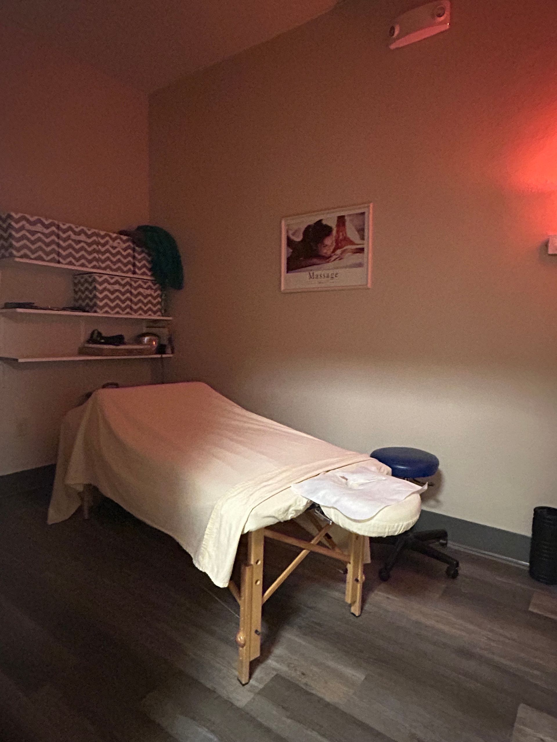 There is a massage table in the middle of the room.