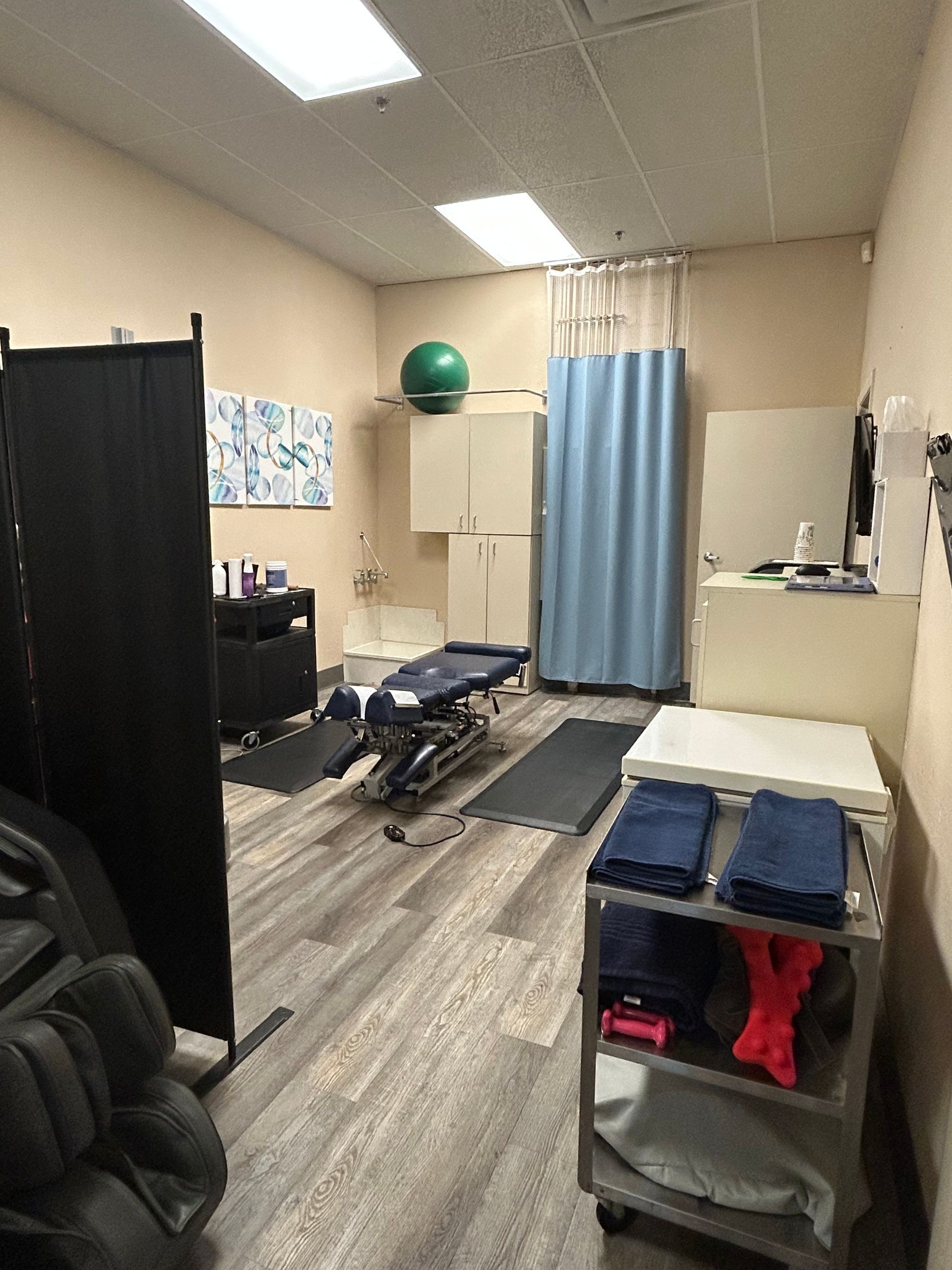 A room with a massage chair and a massage table