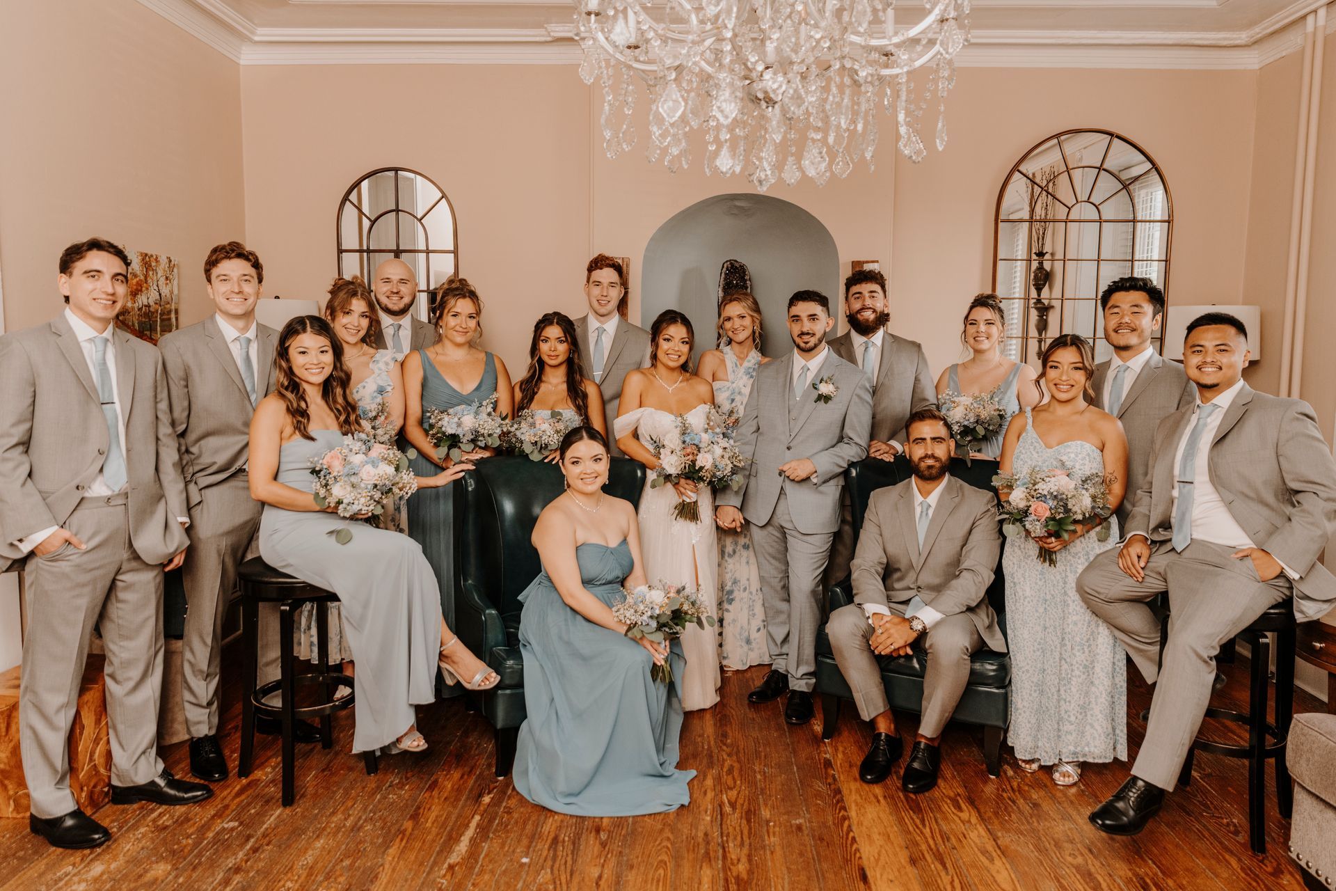 A large group of people are posing for a picture in a room.