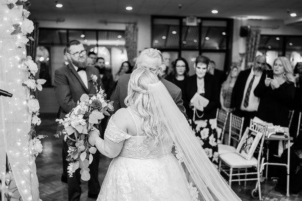 A bride and groom are walking down the aisle at their wedding.
