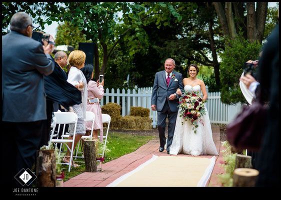 A bride and groom are walking down the aisle at their wedding