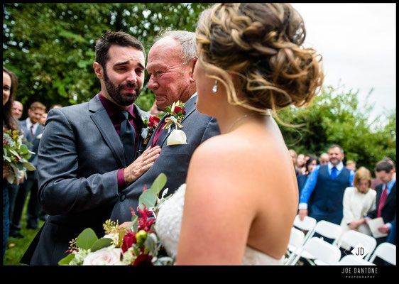 A bride and groom are walking down the aisle at their wedding