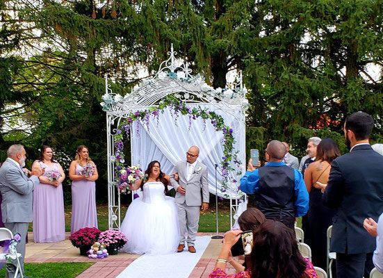 A bride and groom are walking down the aisle at a wedding ceremony.