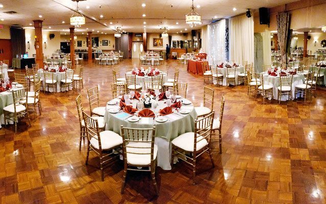 A large room with tables and chairs set up for a party