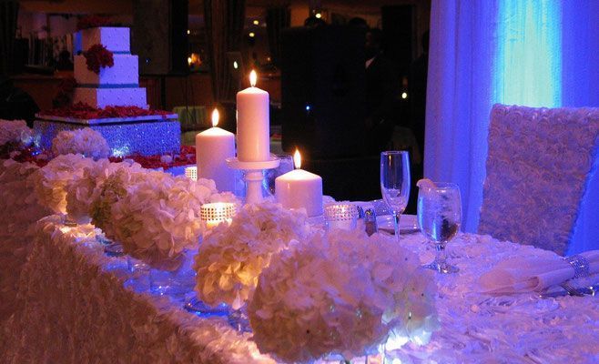 A long table with candles and flowers on it
