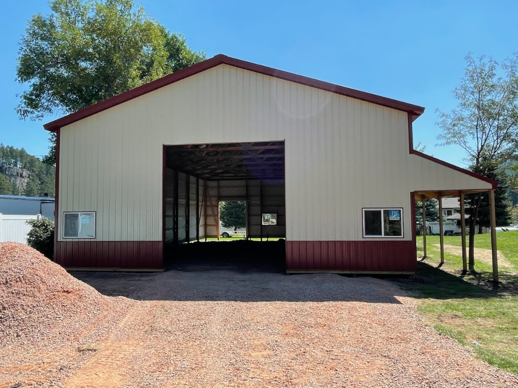 A large white and red building with a large garage door.