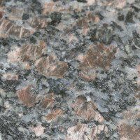 A close up of a granite counter top with a lot of rocks on it.