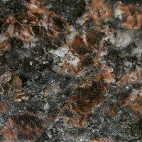 A close up of a brown and black granite texture.