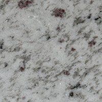 A close up of a white granite counter top.