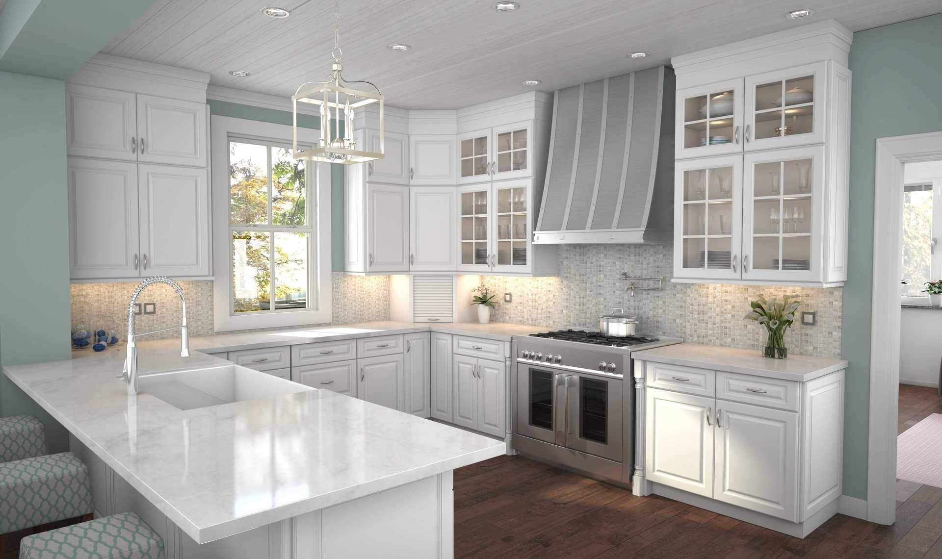 A kitchen with white cabinets , stainless steel appliances , and a large island.