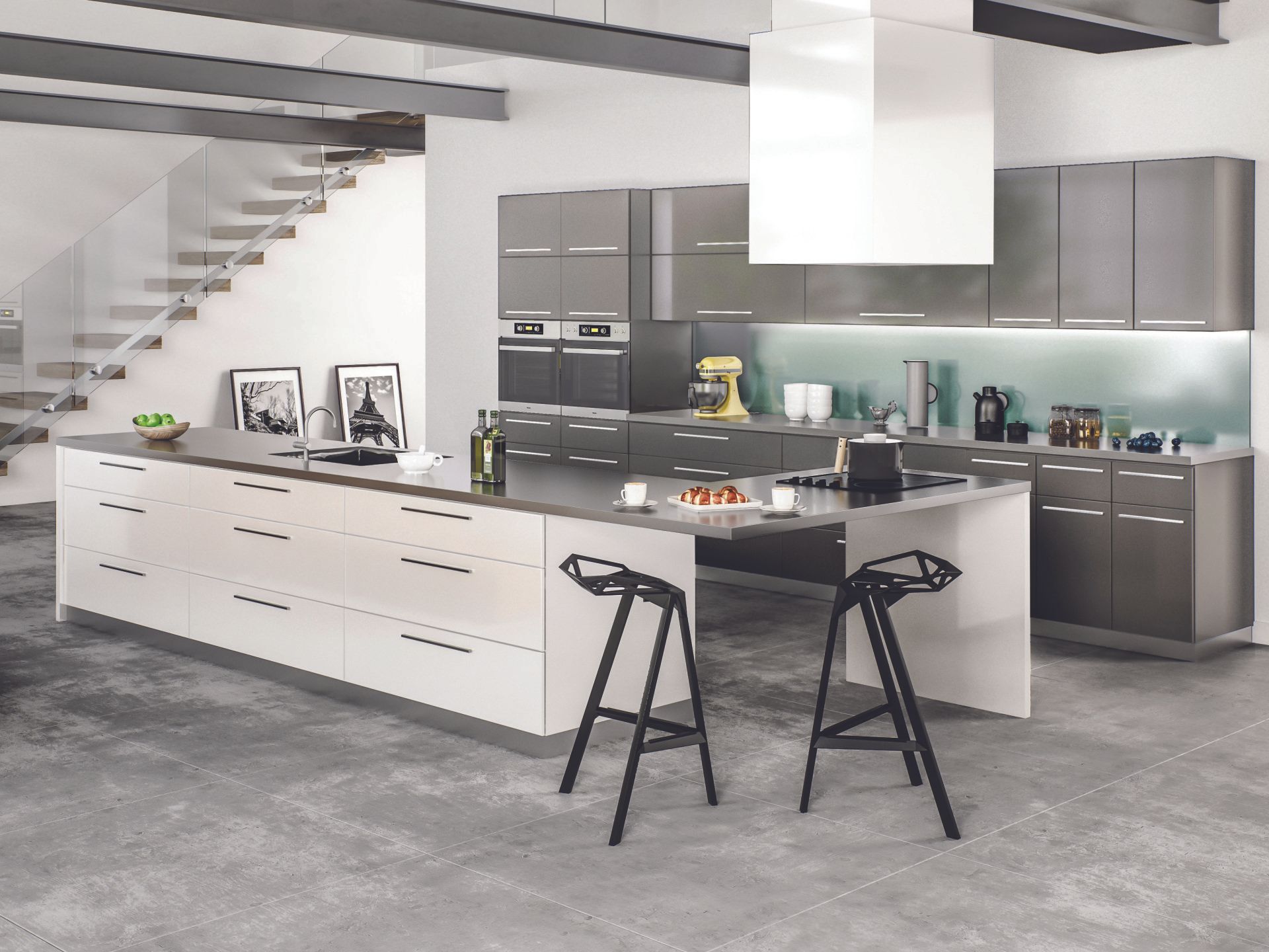 A kitchen with a large island and two stools