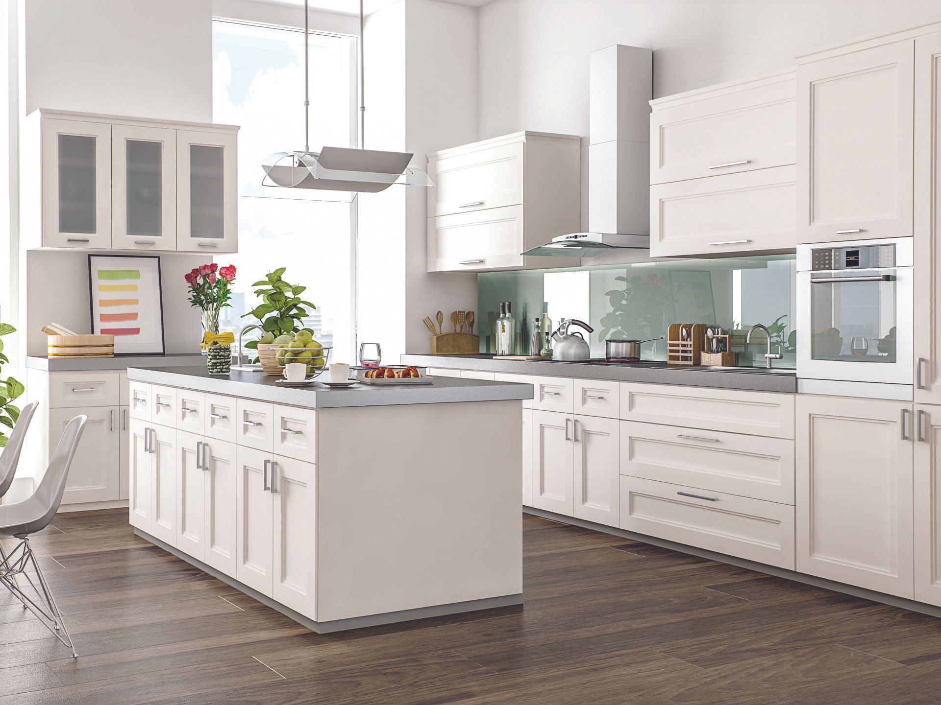 A kitchen with white cabinets and a large island in the middle.