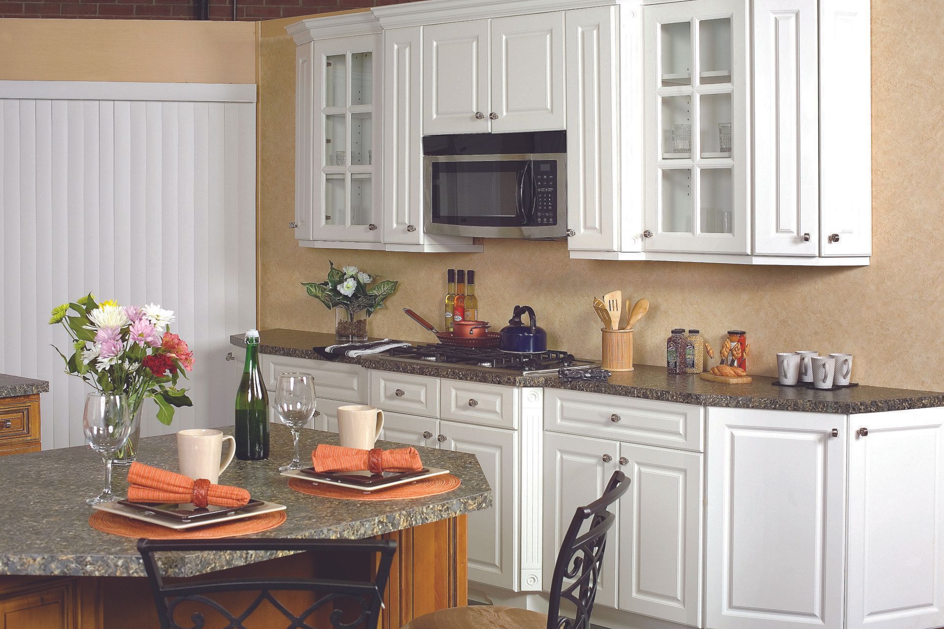 A kitchen with white cabinets and granite counter tops