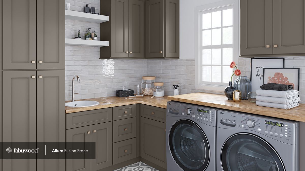 A laundry room with a washer and dryer and a sink.