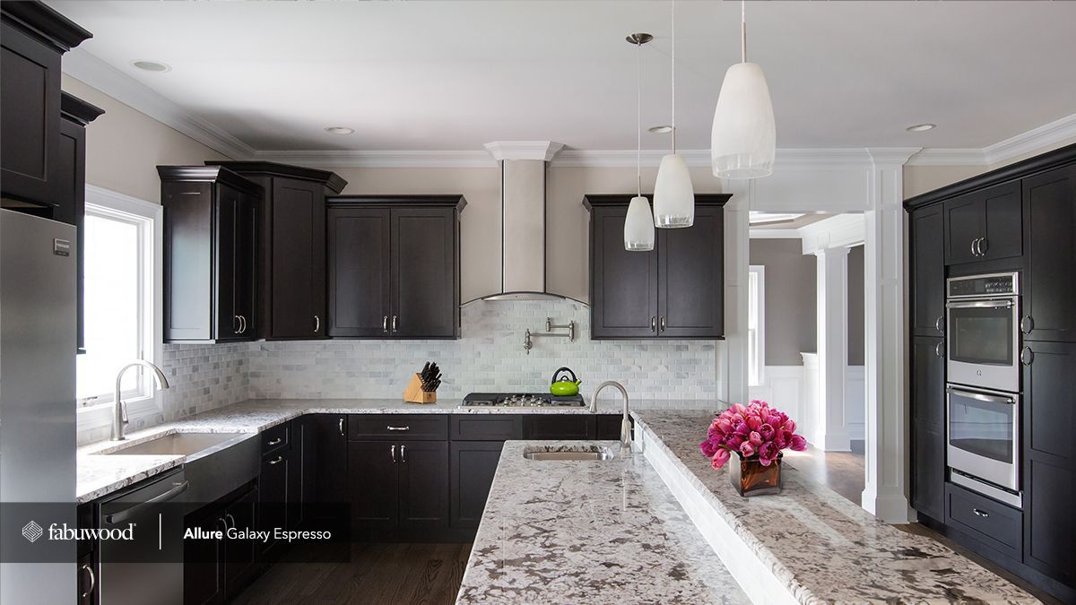 A kitchen with black cabinets and granite countertops