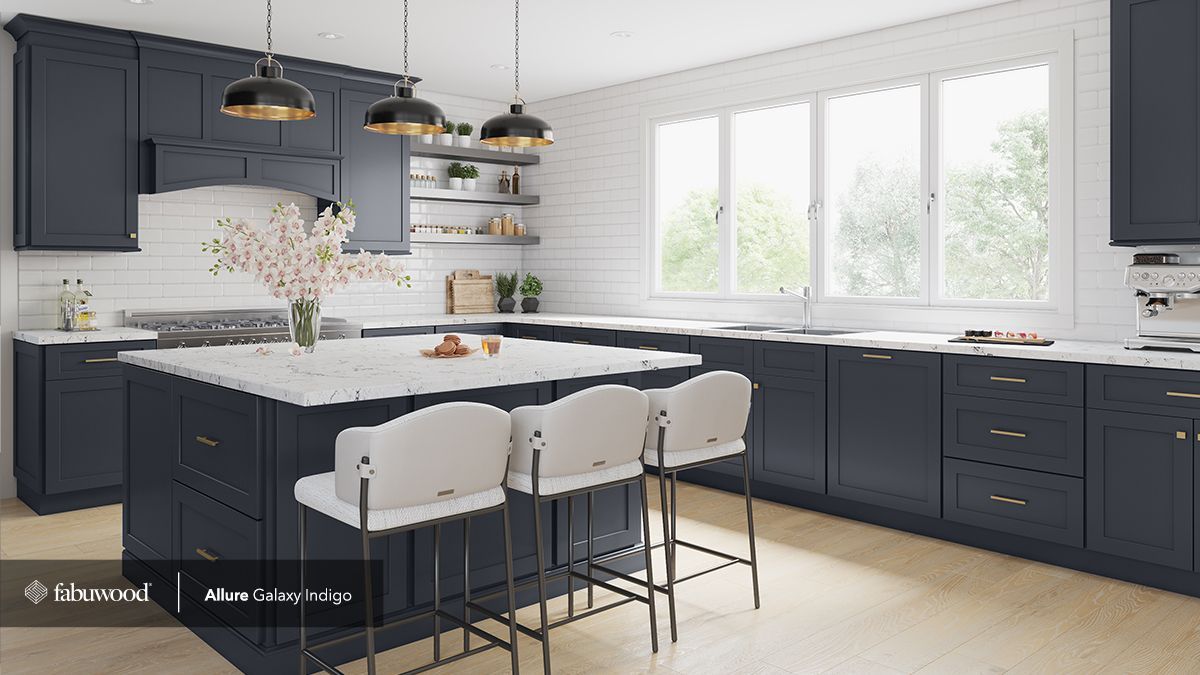 A kitchen with blue cabinets, white countertops, and a large island.