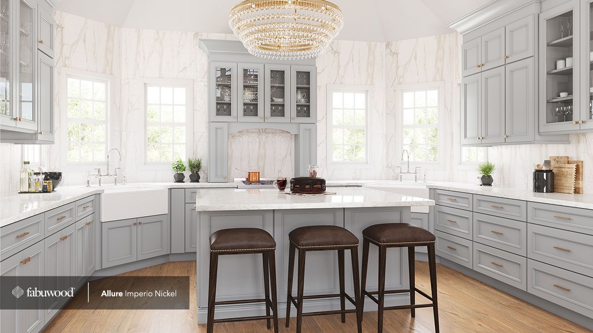 A kitchen with gray cabinets, white countertops, and a large island.