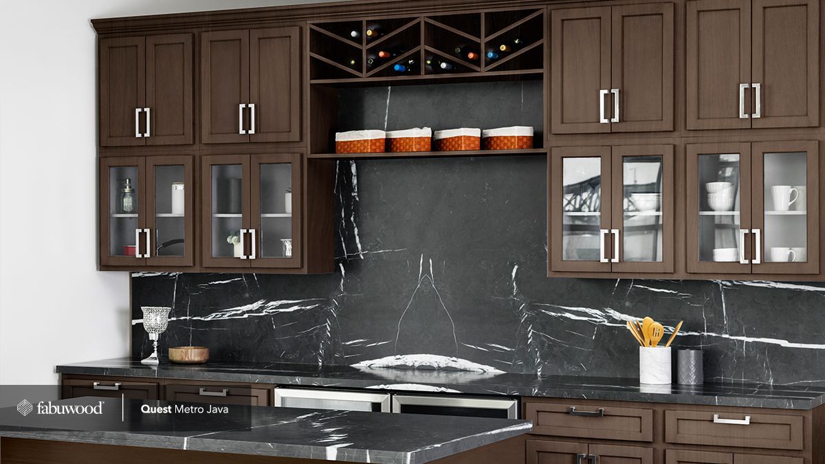 A kitchen with brown cabinets and black countertops