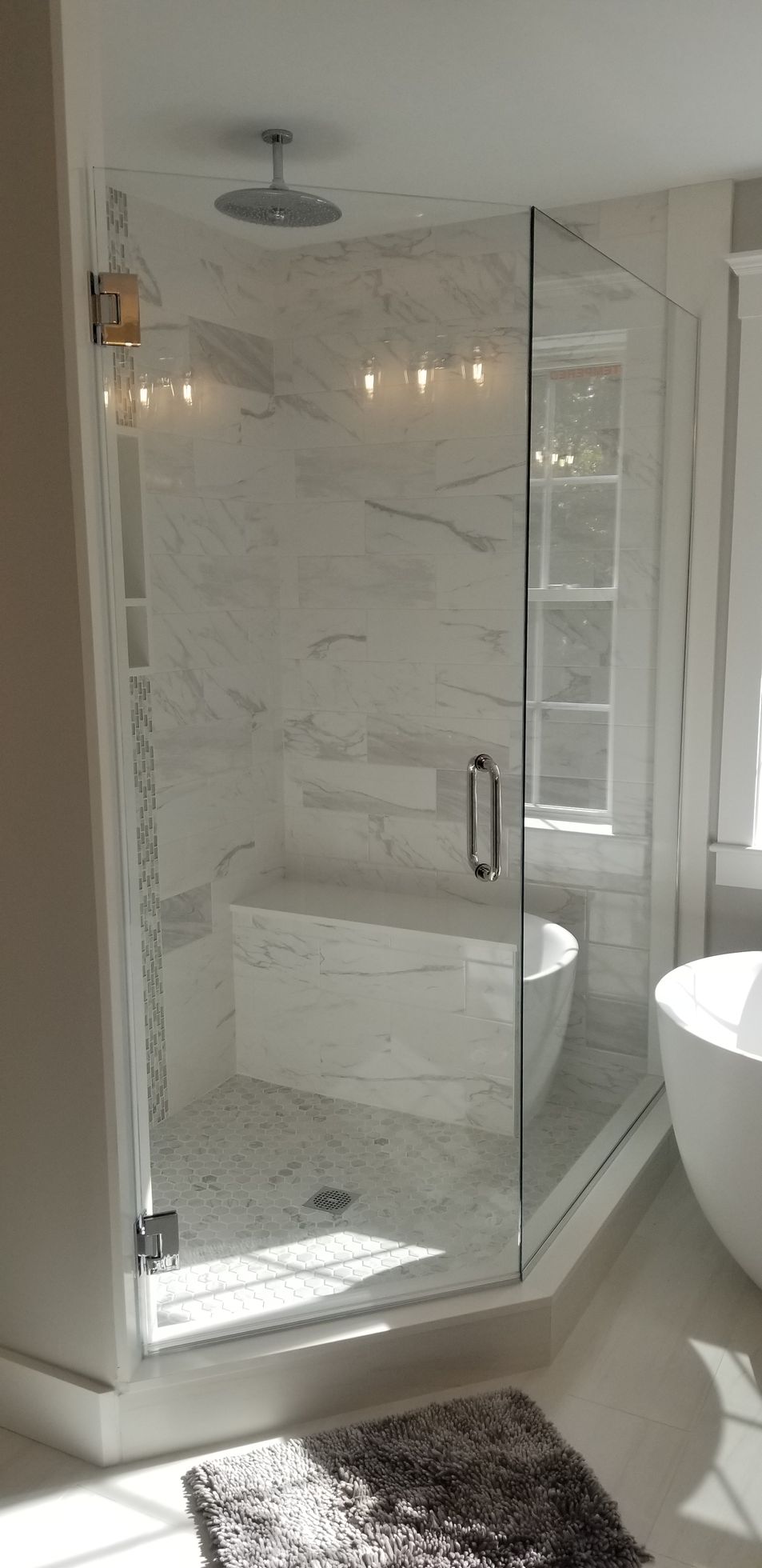 A bathroom with a walk in shower and a bathtub.