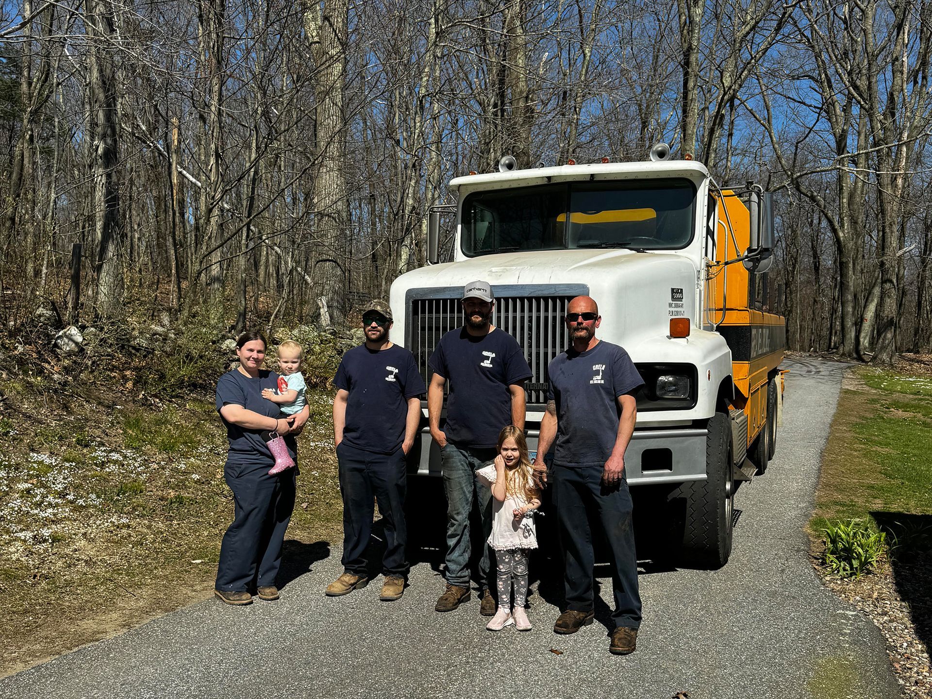 A group of people are standing in front of a truck.