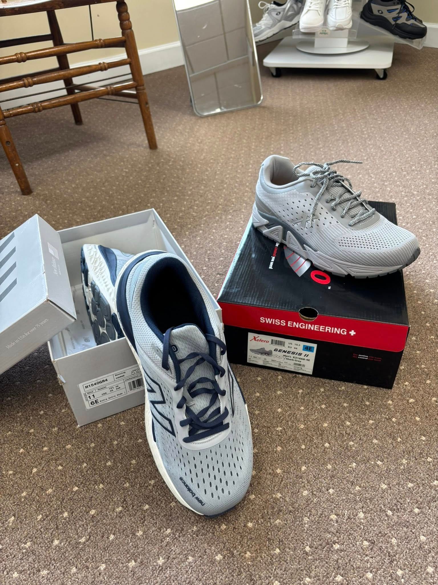 Two pairs of gray athletic shoes, one in a box, on a carpeted floor.